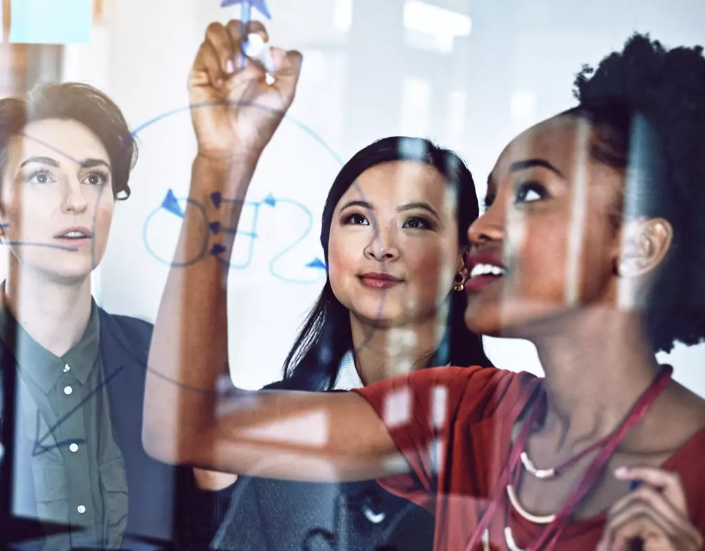 Certified Agile Consultant leading a dynamic stand-up meeting, a staple in Agile Methodology, with a diverse project team.