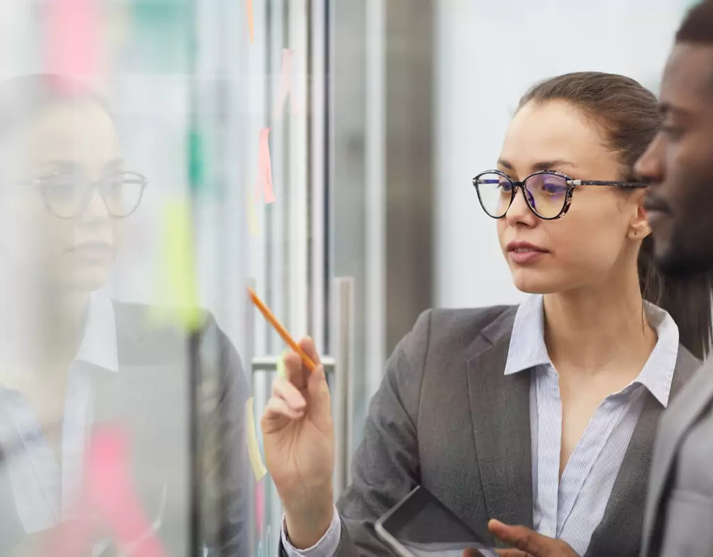Team utilizing a Kanban board, an essential tool in Custom Agile Solutions, for task prioritization in an Agile work environment.